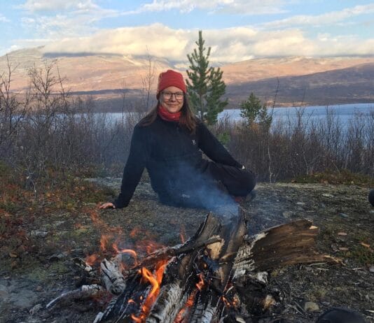 Elin Marakatt is Sami sitting in front of a fire