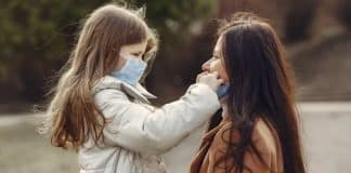 mother and daughter wearing masks