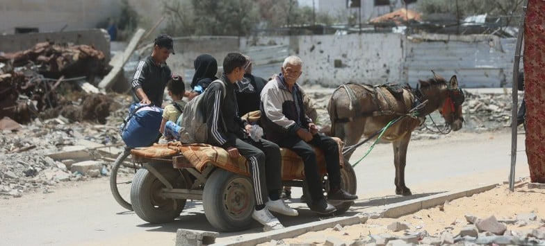 UN News | A displaced family travels on a donkey-pulled cart carrying their belongings.
