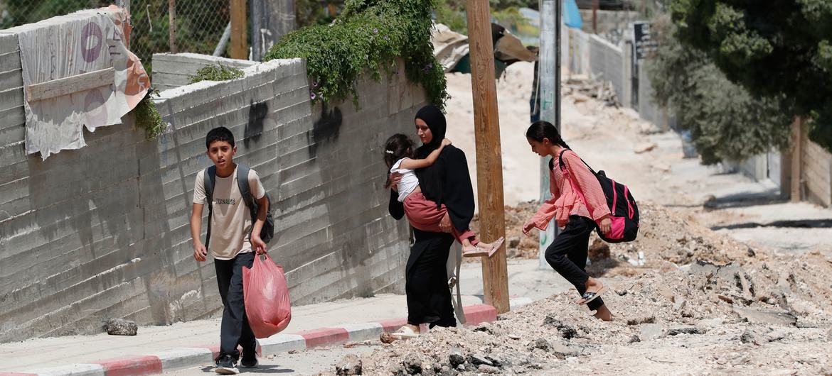 Members of a family flee Jenin due to an escalation of violence.