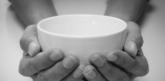 Person holding empty bowl