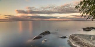 A calm sea, rocks and a horizon