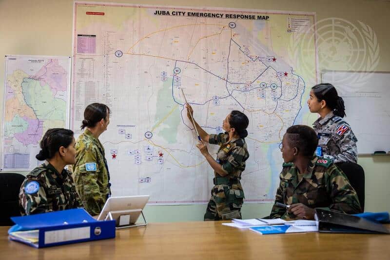 Atupele Mbewe, Bindeshwari Tanwar and Ritu Pandey, UNMISS peacekeepers from Malawi, India and Nepal, respectively, are photographed with colleagues at the mission’s headquarters in Juba, South Sudan. Photo: UN Photo/Gregório Cunha