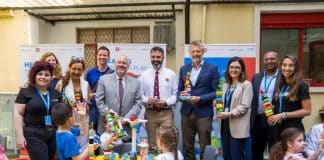 A group of people with colorful bricks