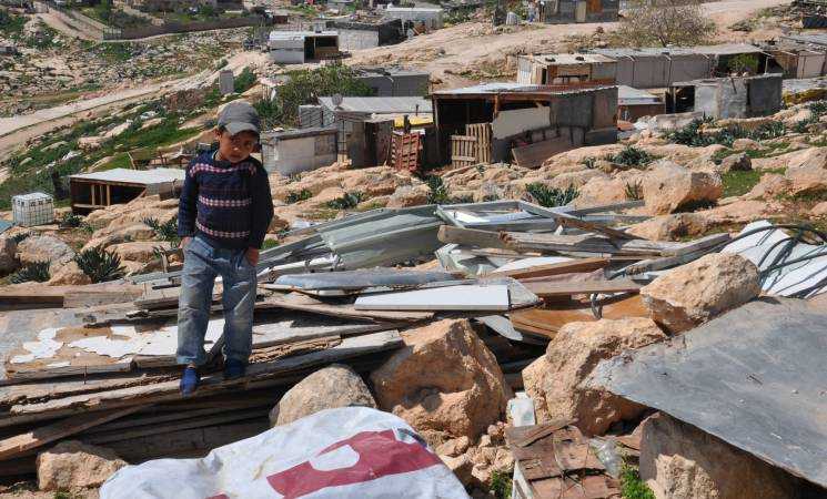 A Bedouin boy living in Jabal al-Baba looks at the remains of his family home demolished in 2017. “UNRWA has been there for us physically, emotionally and financially, but particularly right after demolitions.” Attalah, Bedouin spokesperson. ©2018 UNRWA Photo by Lára Jónasdóttir