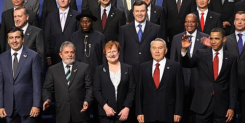 A number of men and women in a formal setting