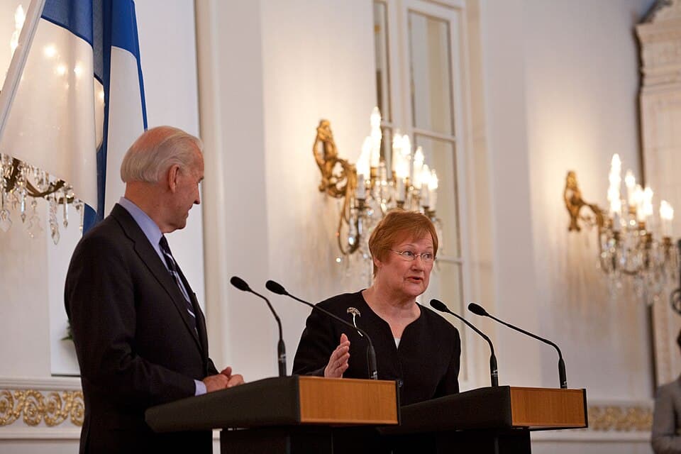 A man and a woman speaking in a formal setting