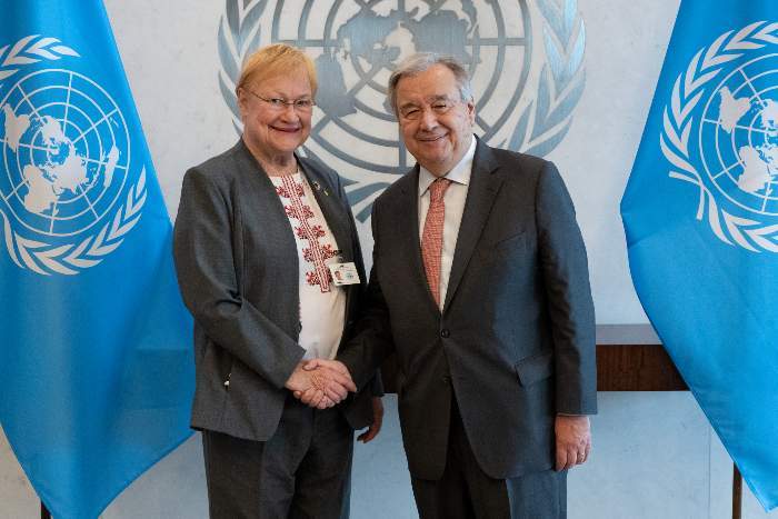 A woman and a man shaking hands in a formal setting
