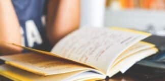 child reading an open notebook
