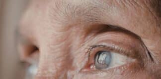cropped portrait showing the eyes of an elderly person staring in the distance