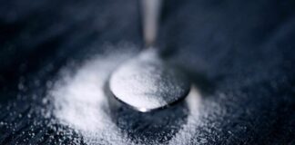 Spoon filled with white powder