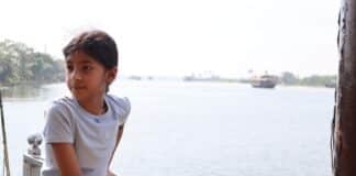 Moksha Roy next to a body of water
