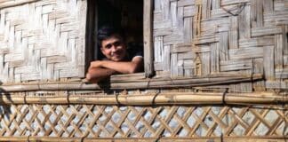 A young man looks out of his shelter in the Rohingya refugee camps in Bangladesh.