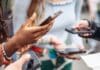 young people holding phones and sharing information