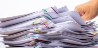 Research papers piled up on a desk