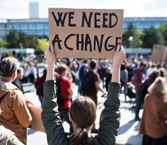 Rear,View,Of,People,With,Placards,And,Posters,On,Global climate change