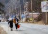Mila Volodymyrivna Khalova, Kyiv, with assistance from a volunteer, heads to the Slovak border