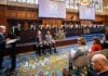 António Guterres spreekt tijdens de 80-jarige bijeenkomst van het Internationaal Gerechtshof in het Vredespaleis in Den Haag, met de rechters op de achtergrond.
