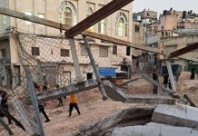 Guterres fördömer israeliska sanktioner riktade mot UNRWA:s verksamhet En krigshärjad stadsvy av barn utomhus